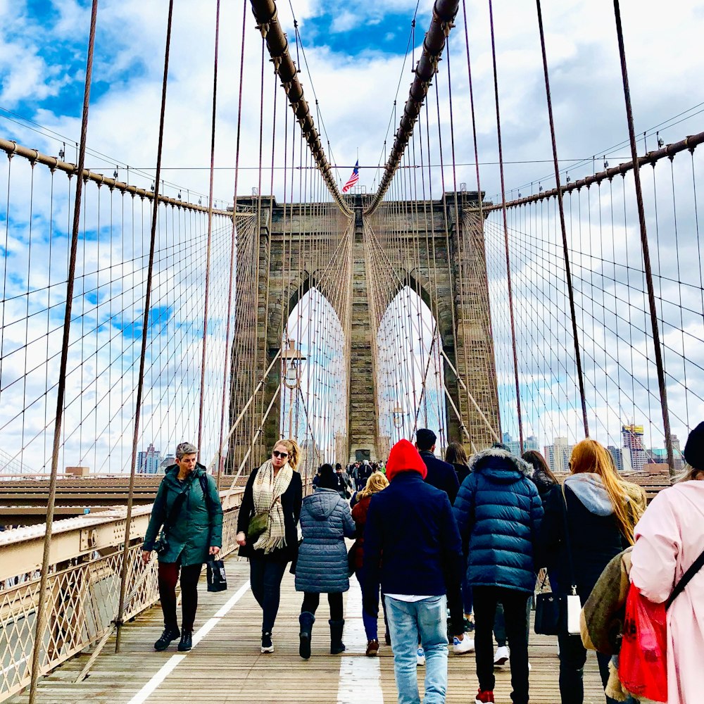 people walking on bridge during daytime