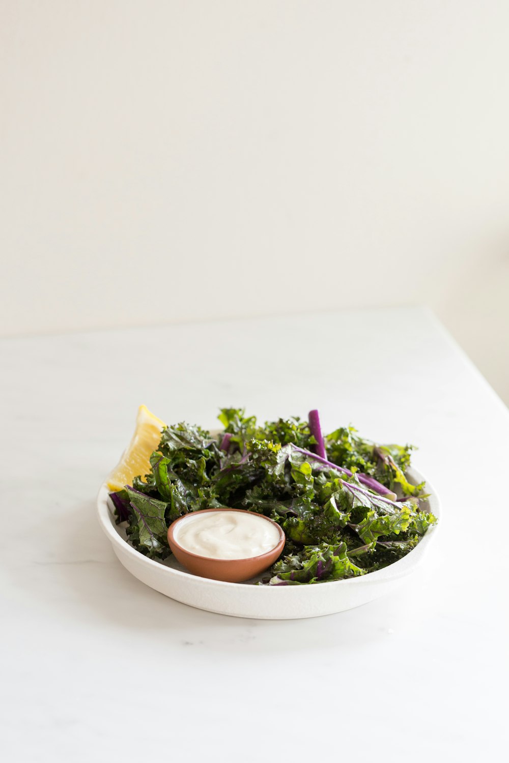 green vegetable salad on white ceramic bowl