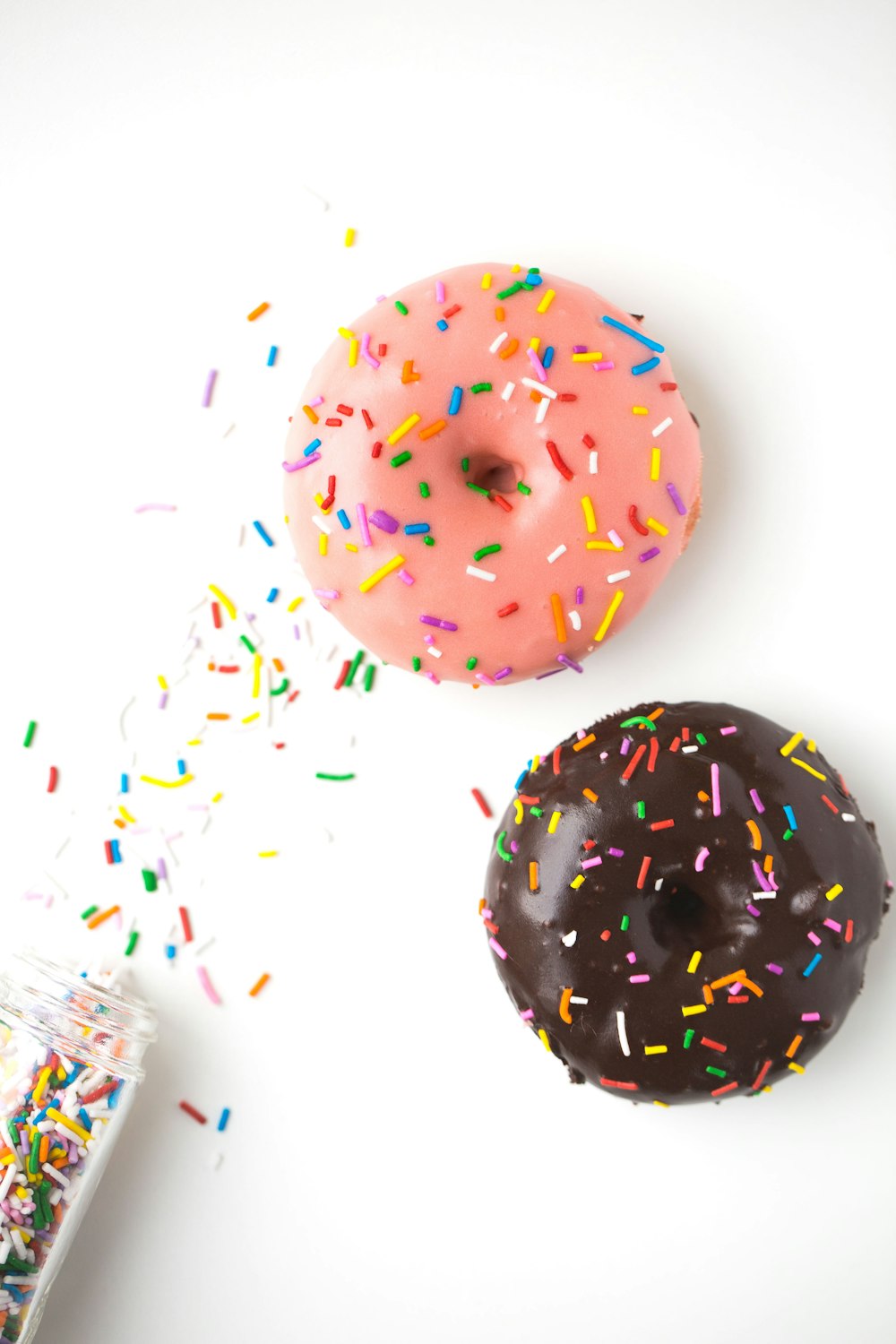 pink and white doughnut on white table