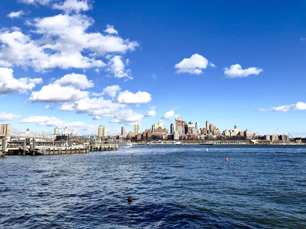 body of water near city buildings during daytime