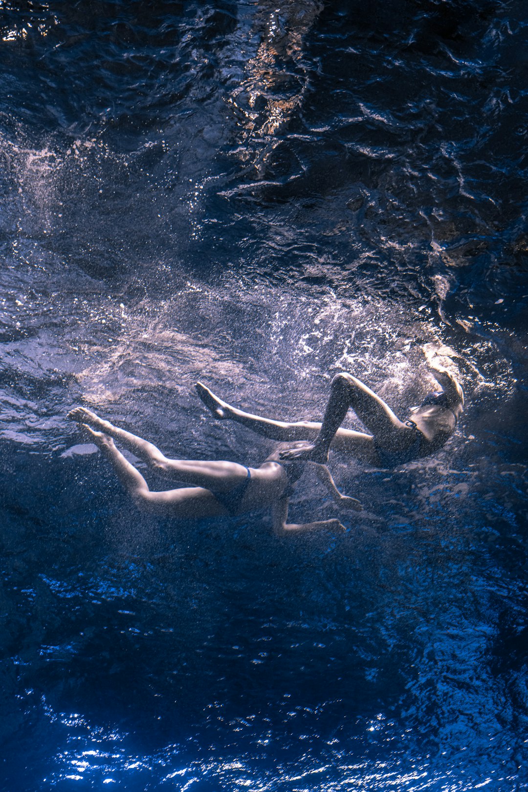 woman in blue bikini swimming on water