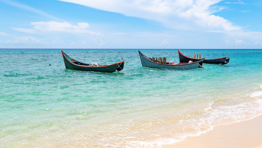 red and blue boat on sea during daytime