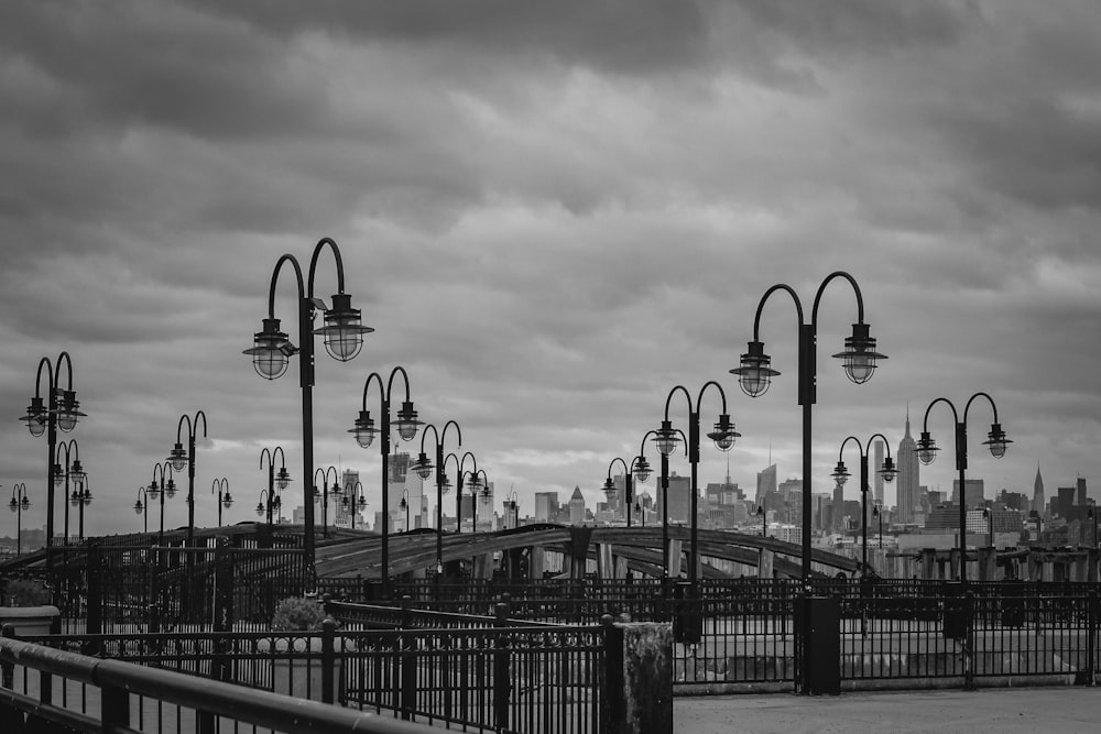 grayscale photo of people walking on bridge