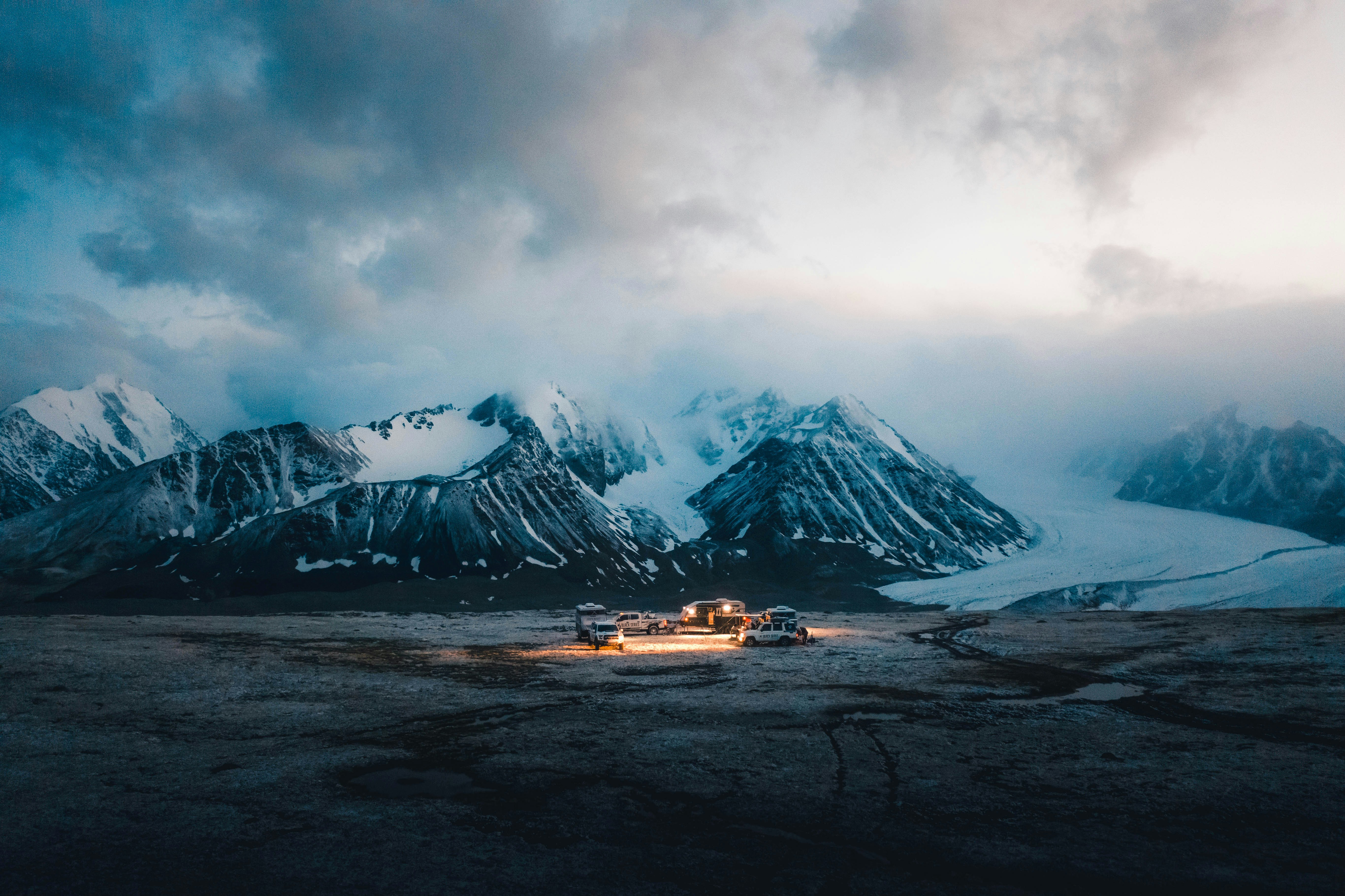 snow covered mountain under cloudy sky during daytime