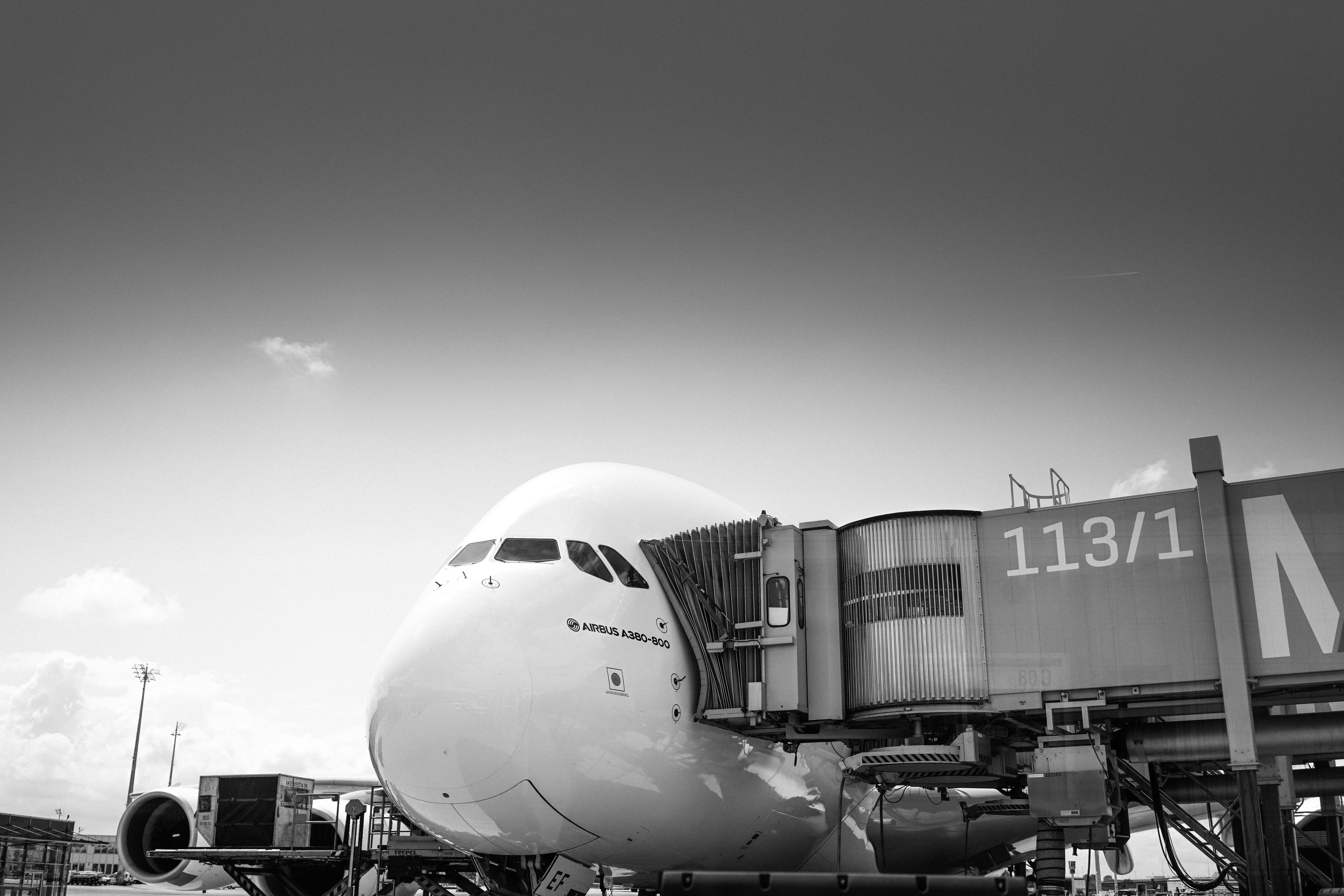airplane in grayscale photography during daytime