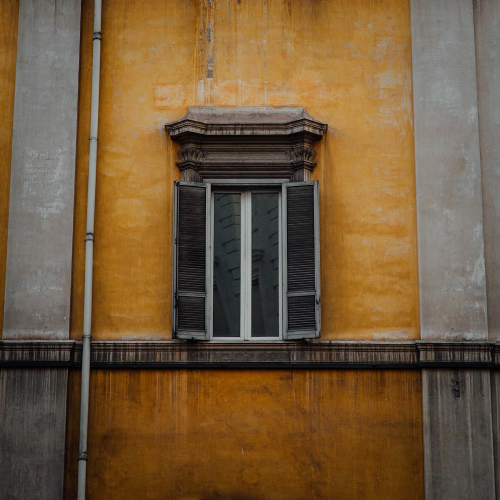 black wooden window on brown brick wall