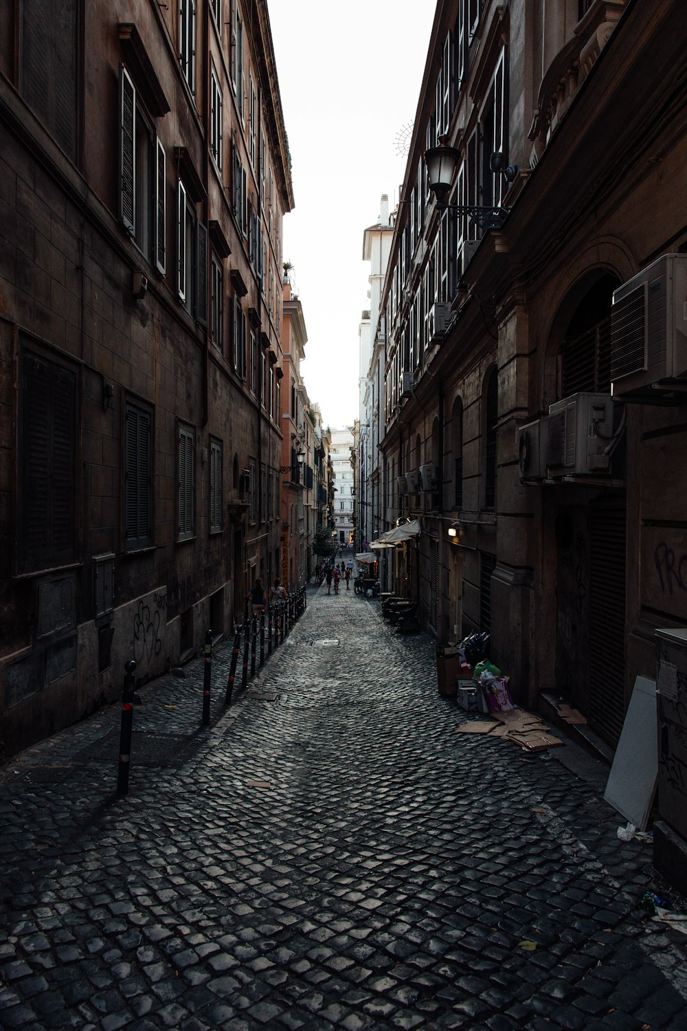 people walking on street between buildings during daytime