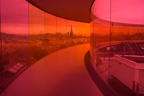 Panoramic elevator with glass walls showcasing a city skyline view.