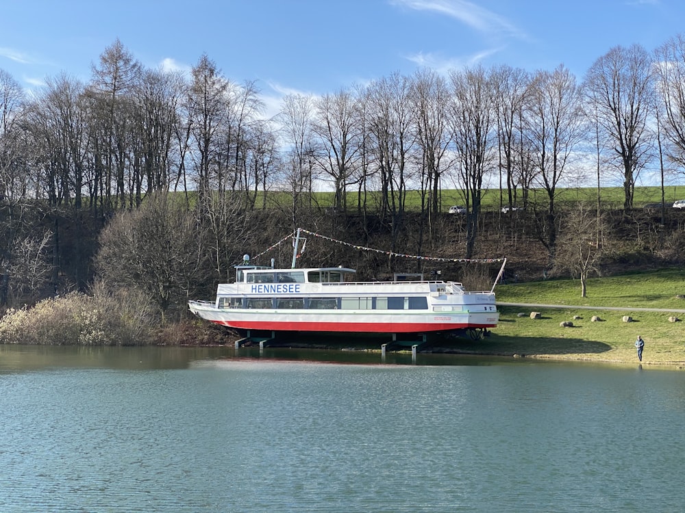 white and red boat on river during daytime