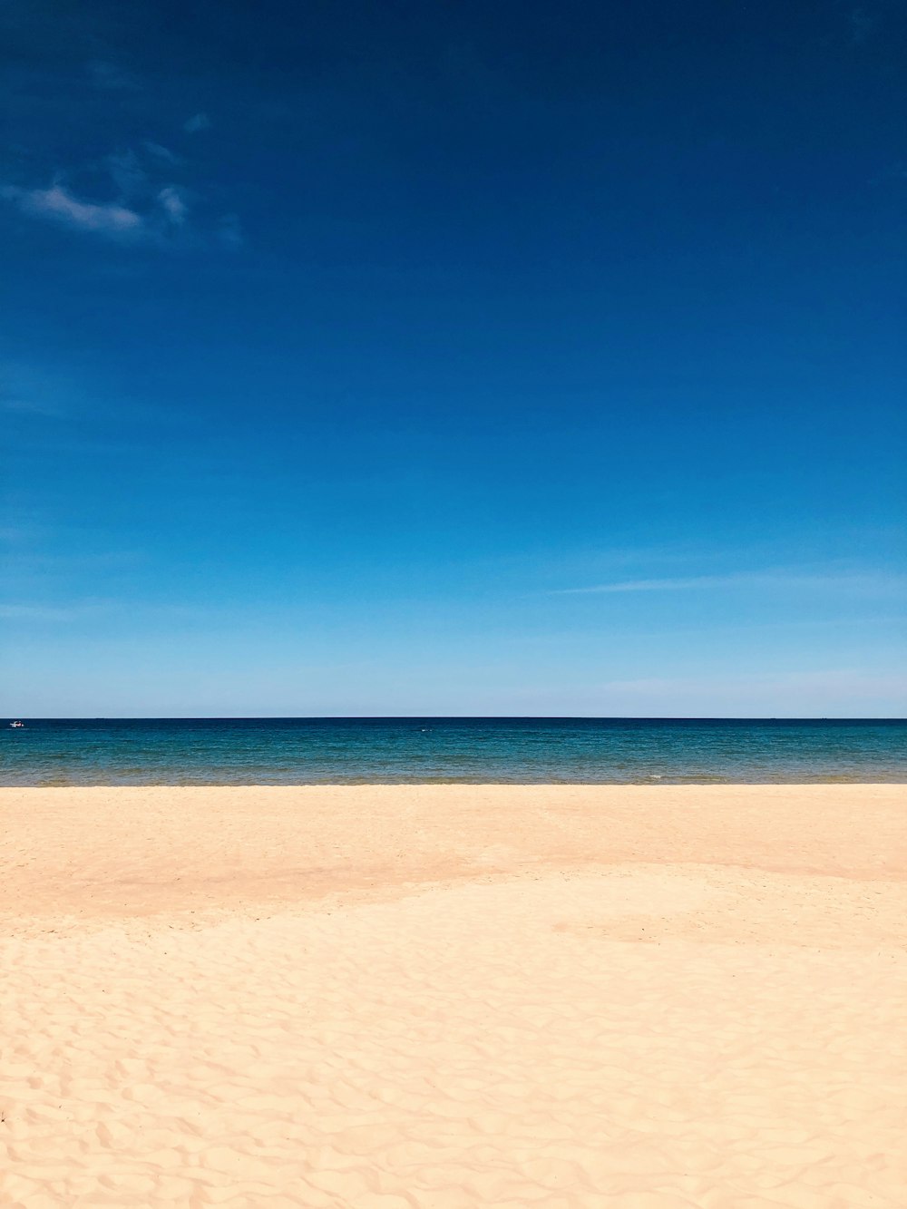 brown sand near body of water during daytime