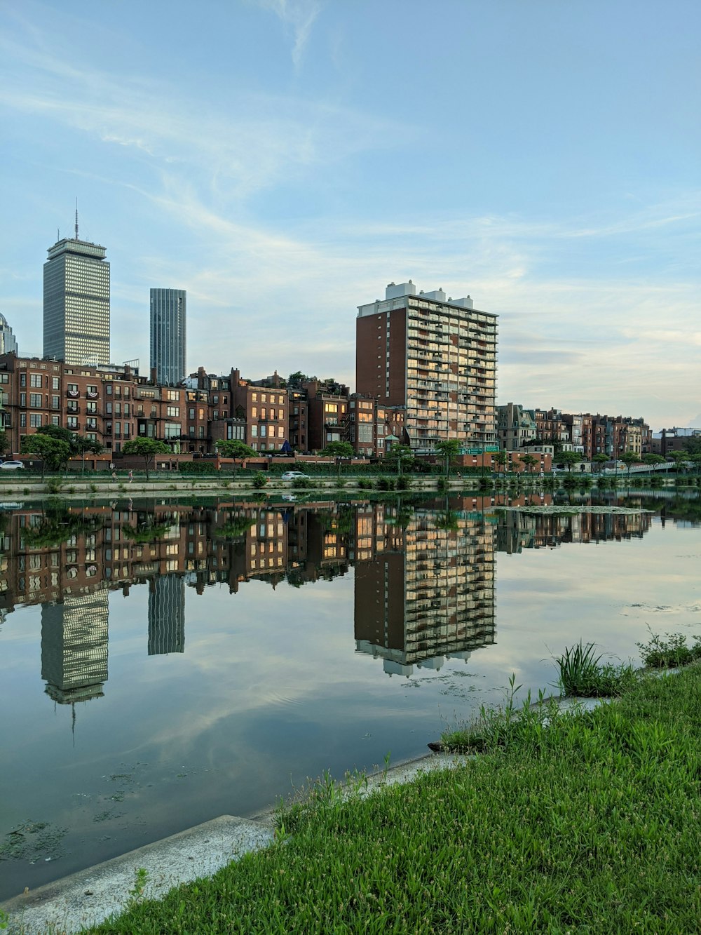 city skyline across body of water during daytime