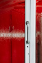 A close-up of a technician polishing a glass door to crystal-clear perfection.