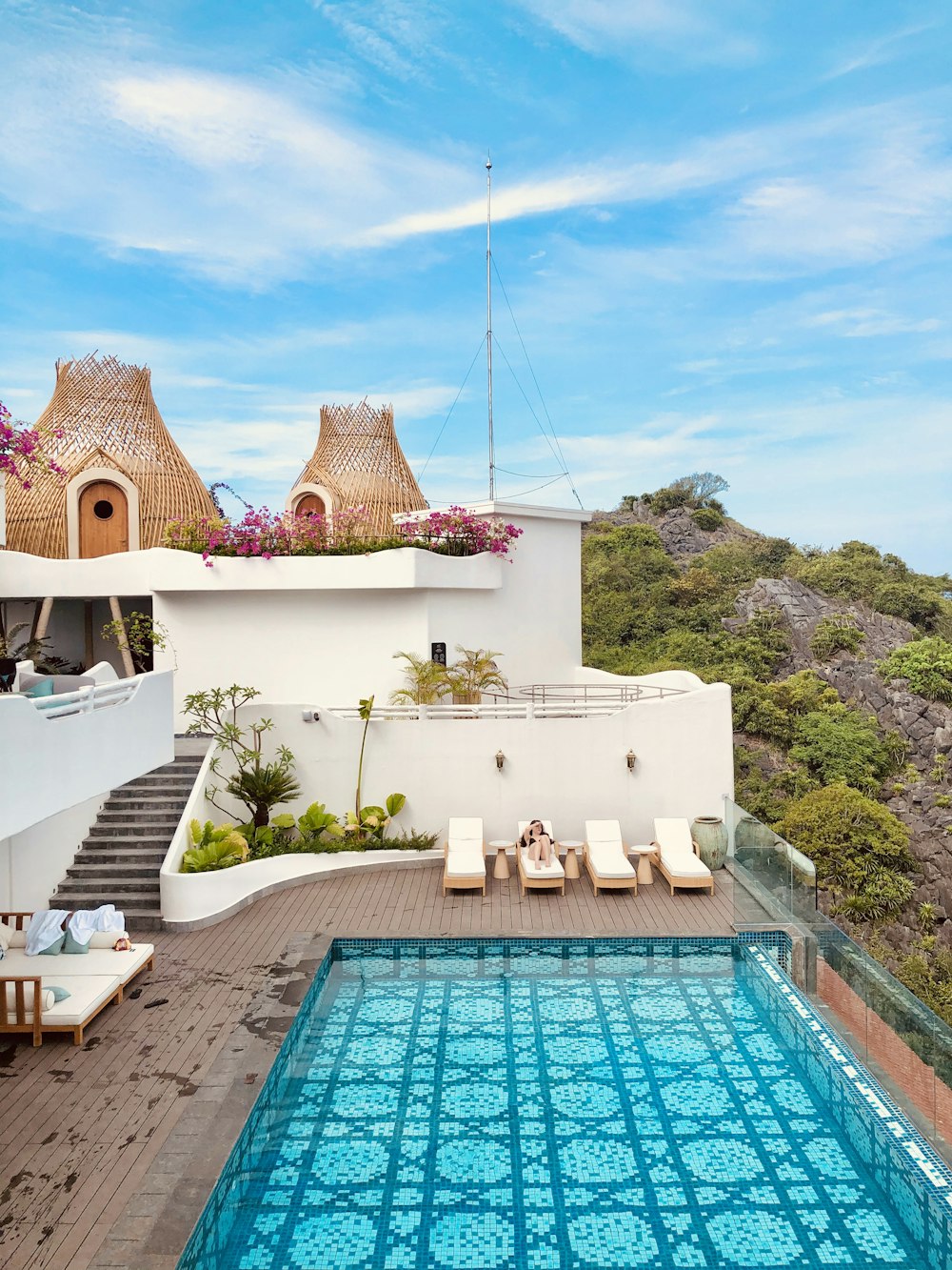 white and brown concrete house near swimming pool during daytime