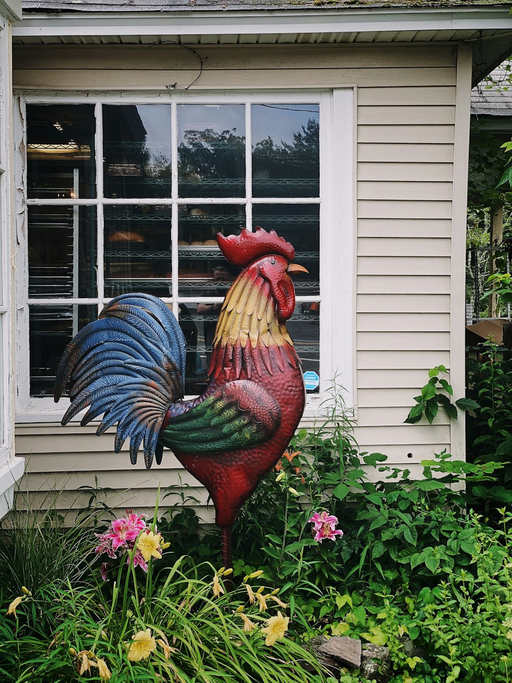 red and blue rooster figurine