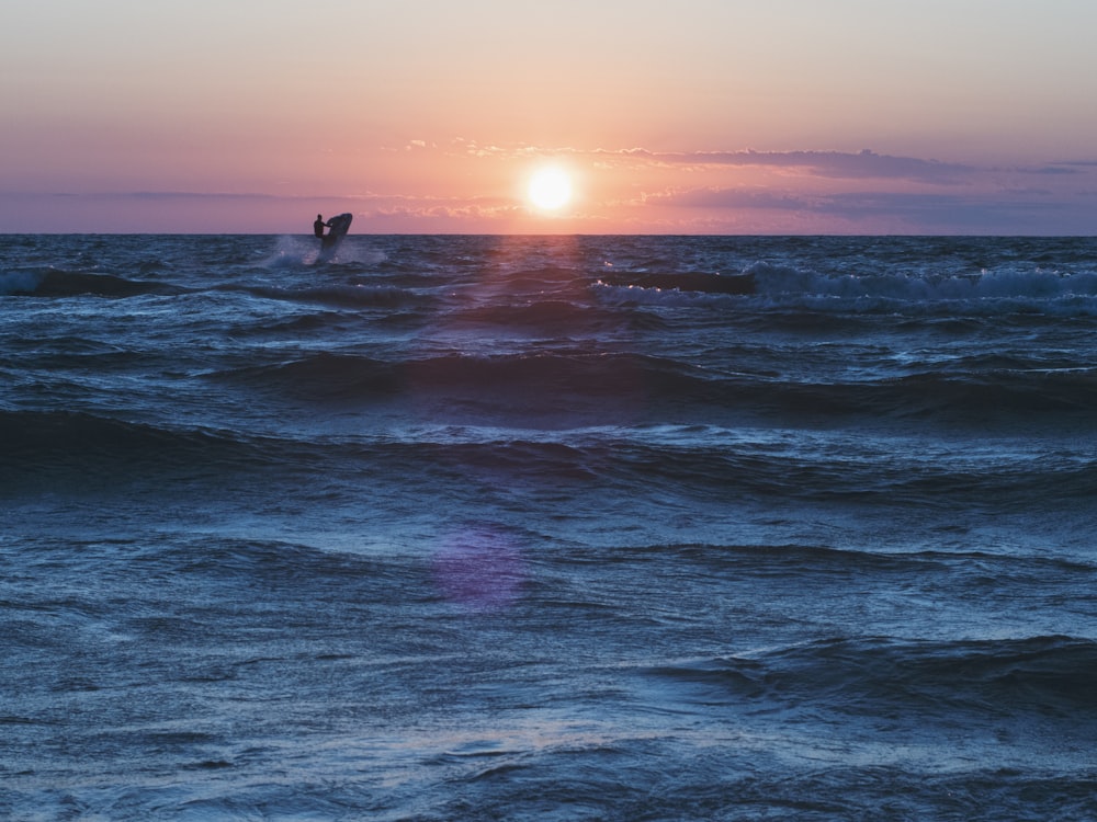 person surfing on sea waves during daytime