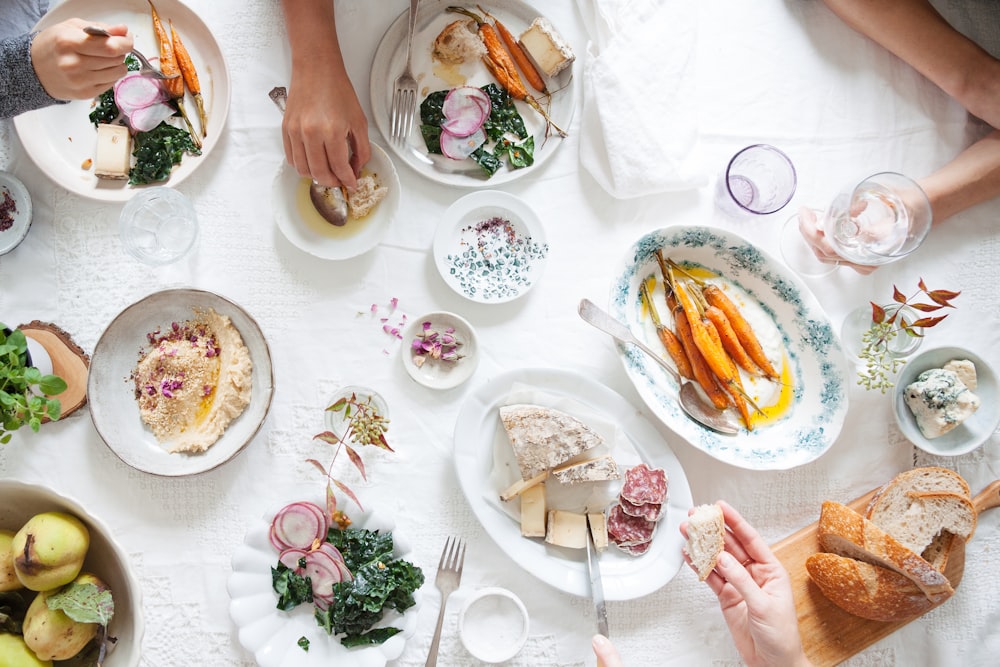 person holding white ceramic plate with food