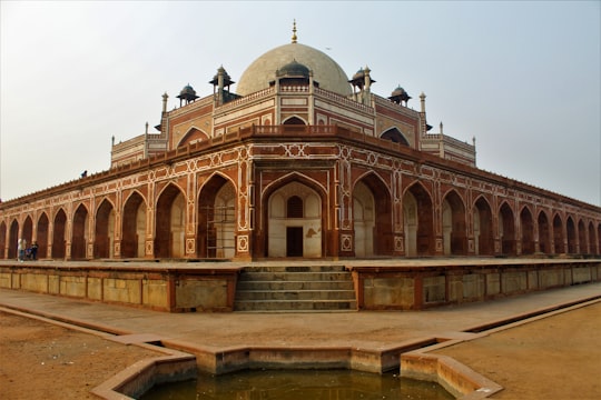 brown concrete building under white sky during daytime in Humayun’s Tomb India