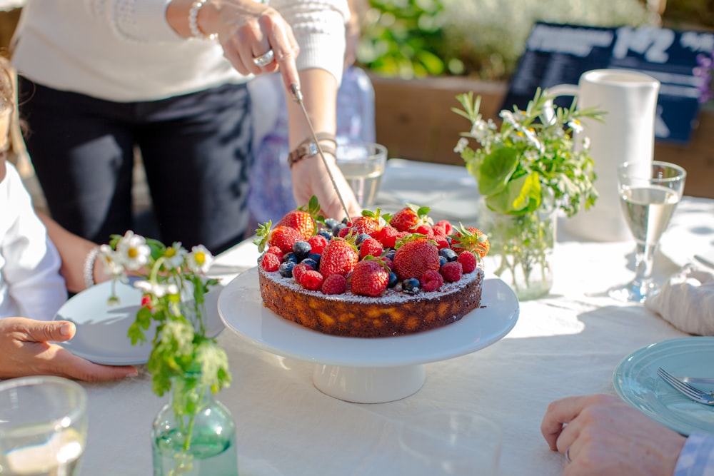 person holding tray of strawberries