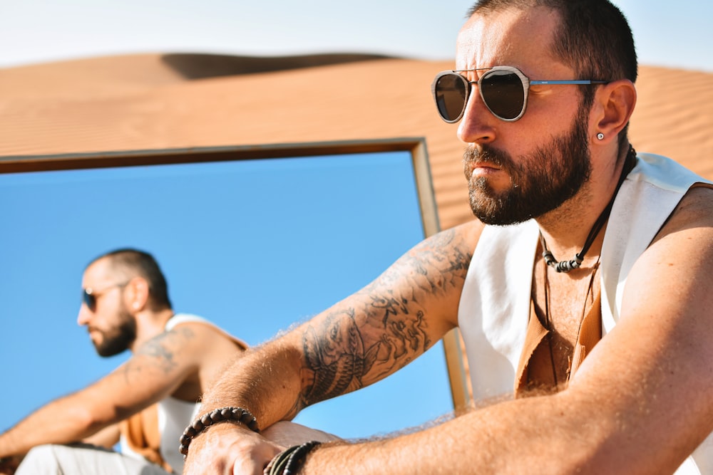 man in white button up shirt wearing black sunglasses