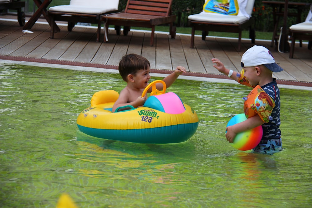 boy in red shirt and white cap on inflatable ring