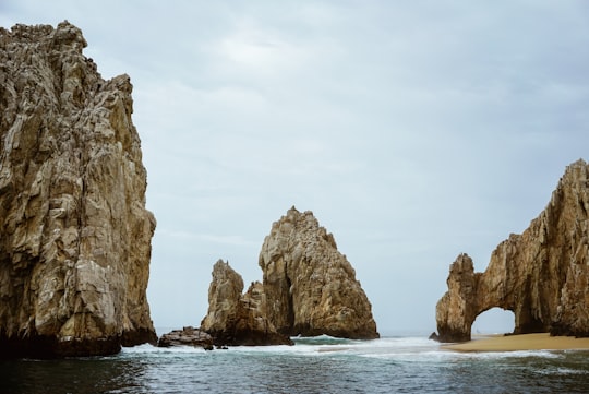 brown rock formation on sea during daytime in El Arco de Cabo San Lucas Mexico