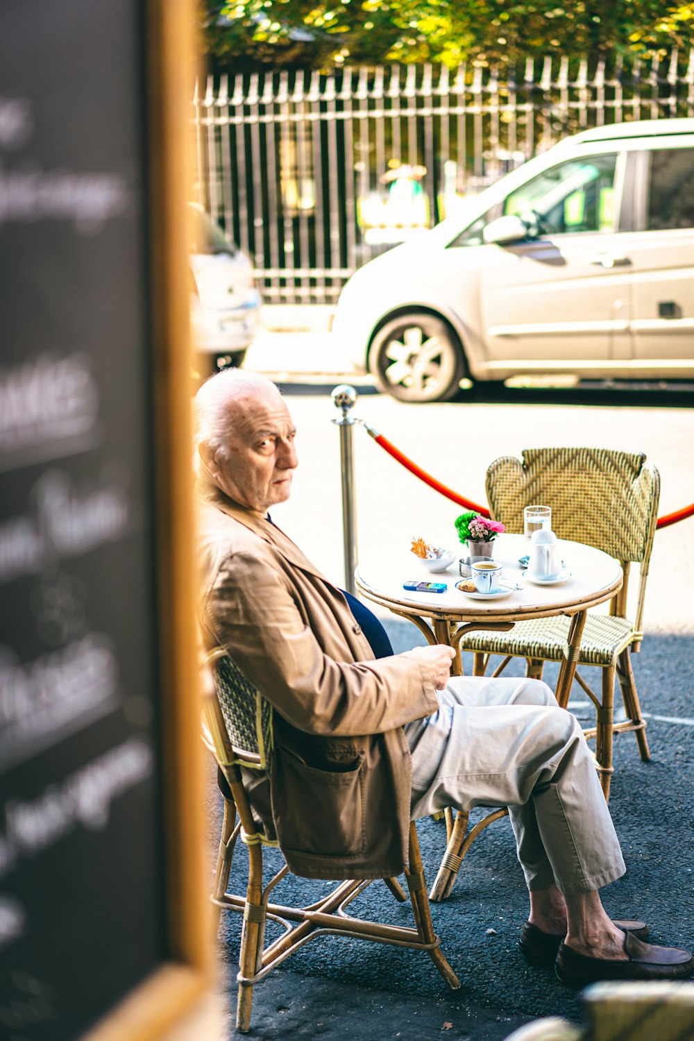 man in brown jacket sitting on chair