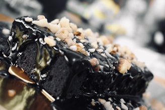 A close-up of a decadent chocolate cake with gold accents.