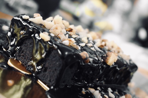 A close-up of a decadent chocolate cake with gold accents.
