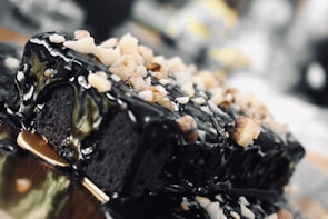 A close-up of a decadent chocolate cake with decorative icing.