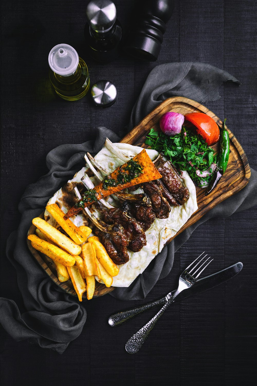 fries and meat on brown woven tray