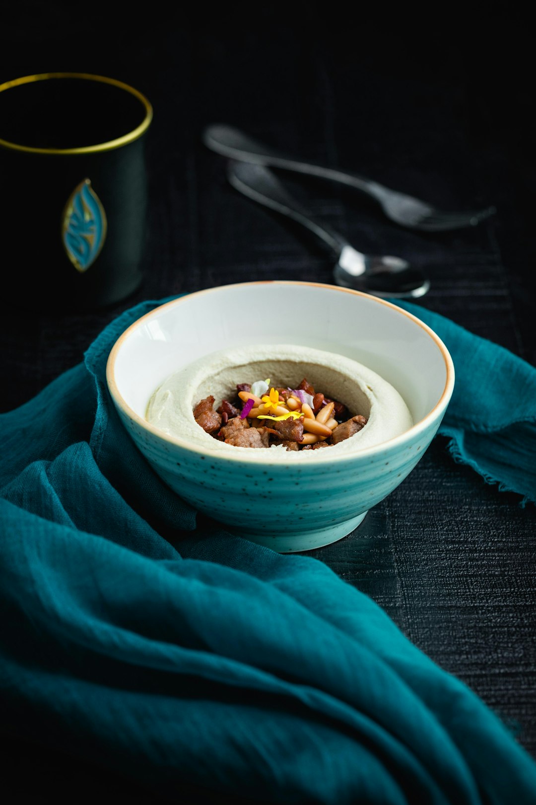 white ceramic bowl on blue textile