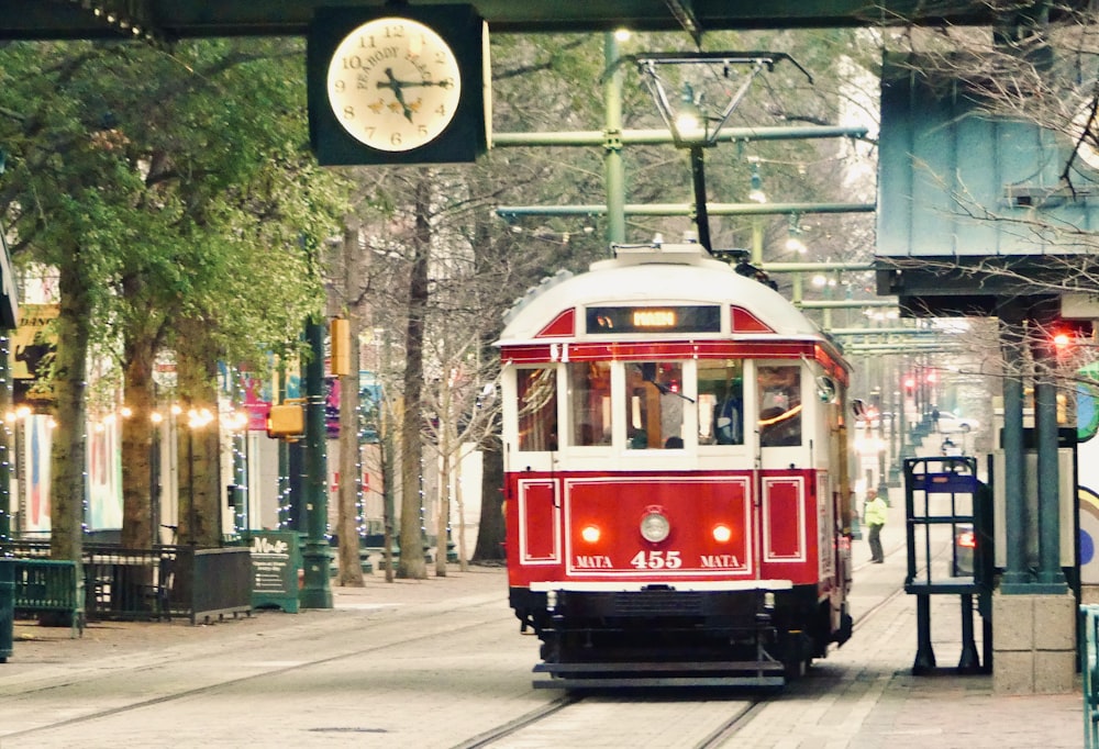 red and white tram on road during daytime