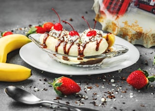 strawberry and banana on white ceramic plate