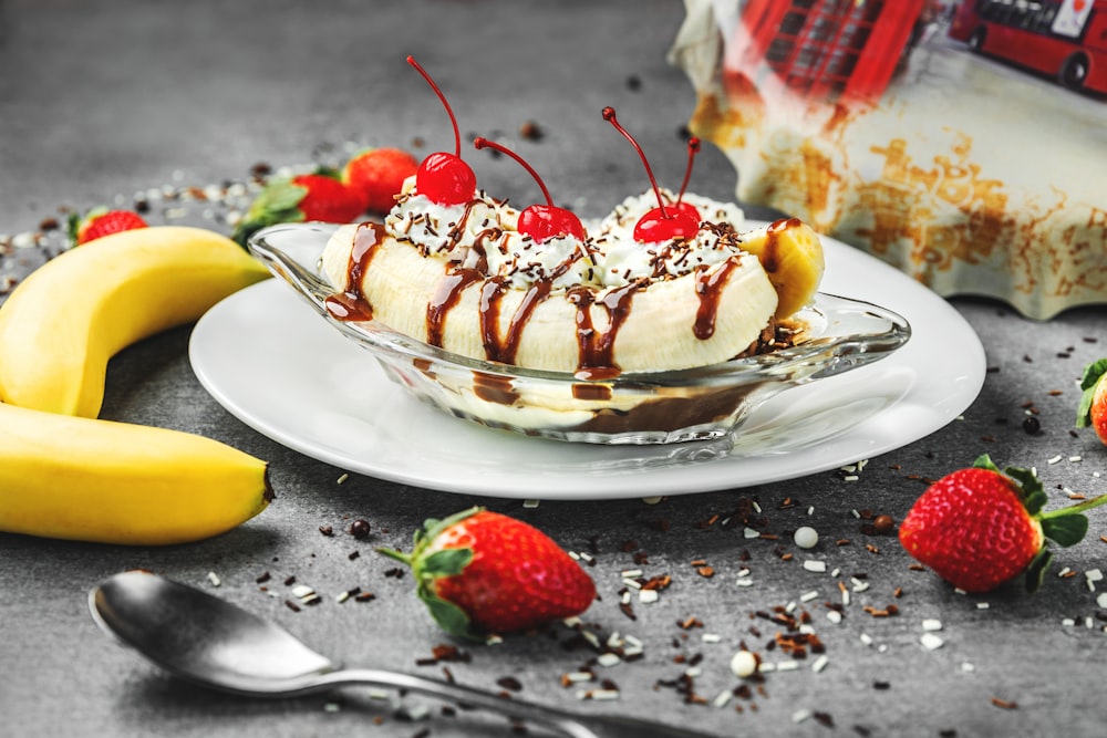 strawberry and banana on white ceramic plate