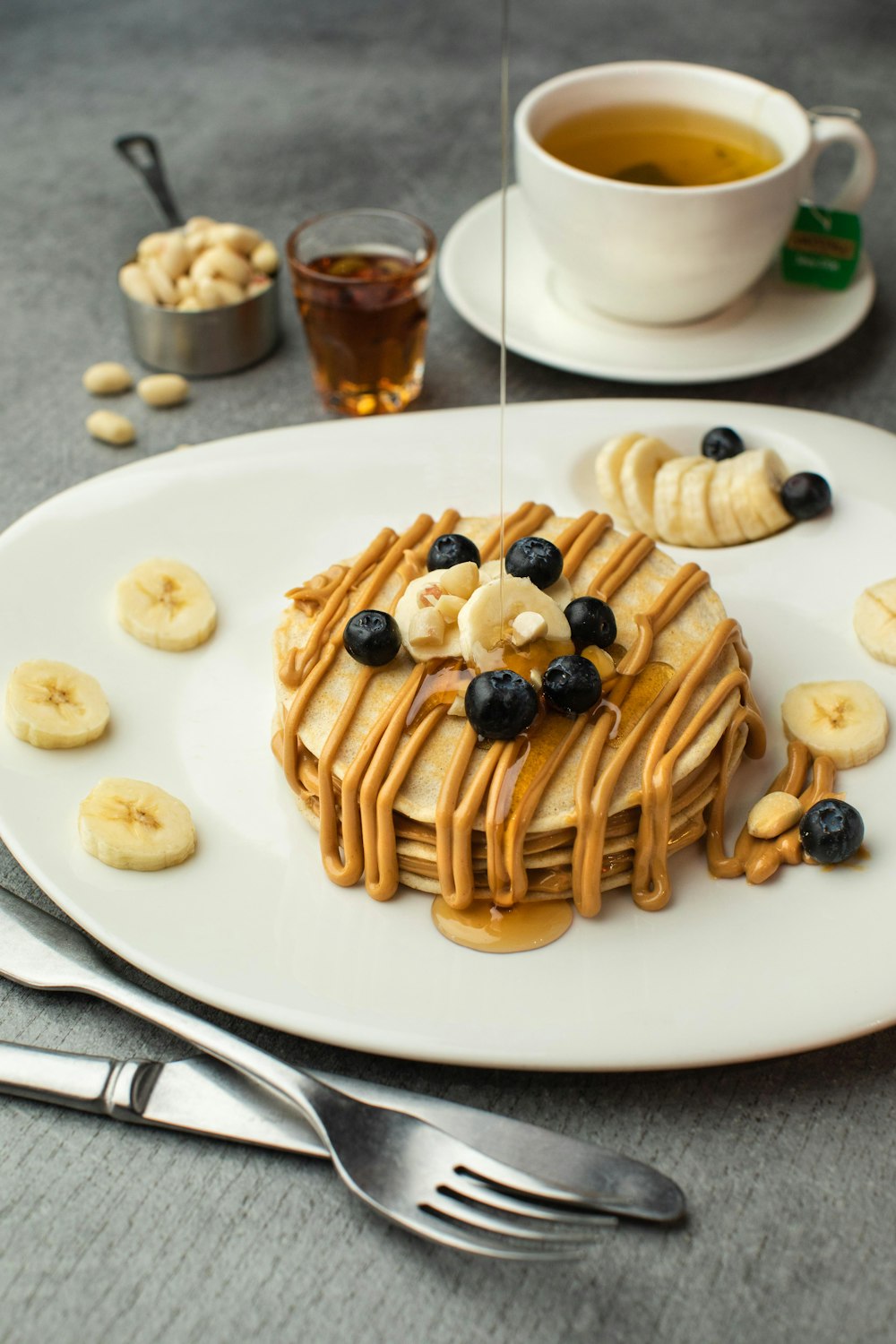 pancakes with black berries on white ceramic plate