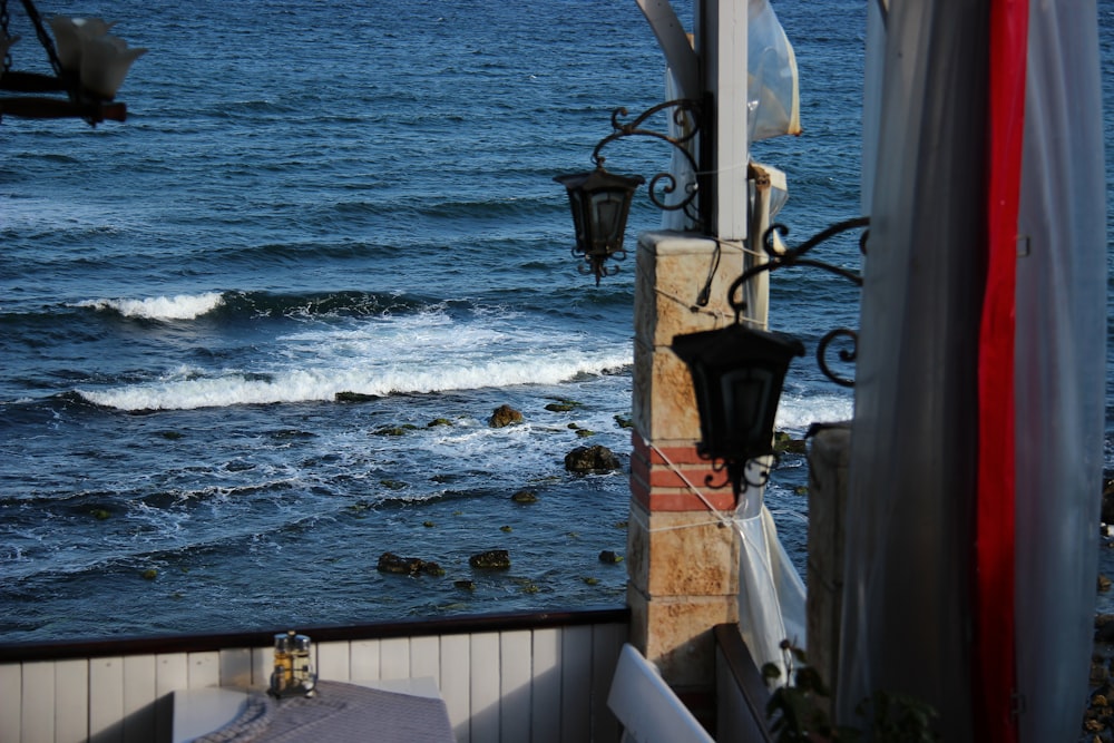 black metal lamp post near sea during daytime