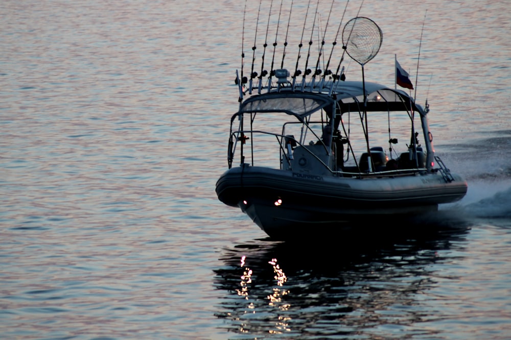 white and black boat on sea during daytime