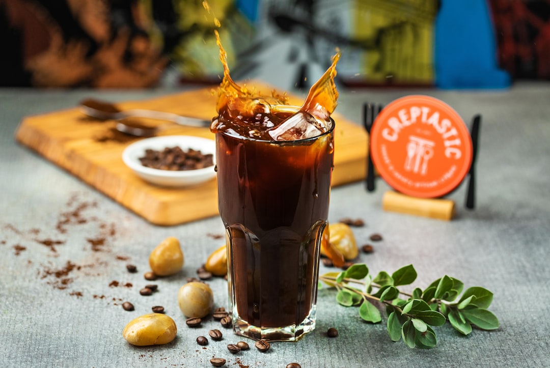 clear drinking glass with brown liquid