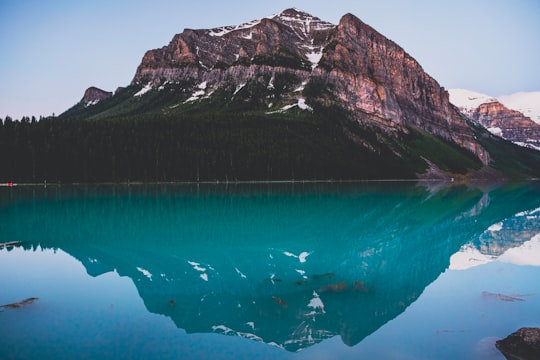 blue water near gray and white mountain during daytime in Banff National Park Canada