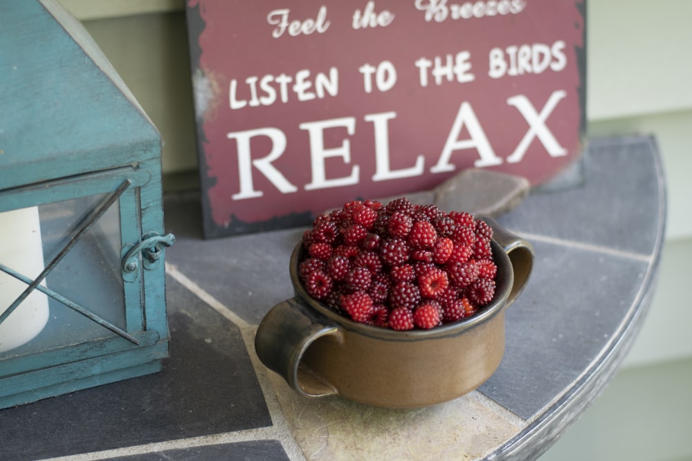 red and black berries in stainless steel bowl