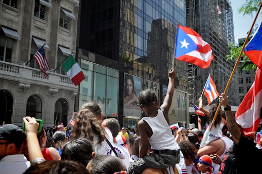 people walking on street with flags during daytime