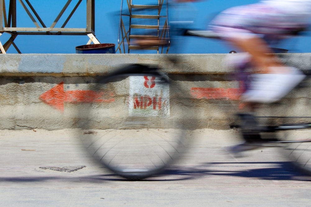 person in white and red shirt and blue denim jeans riding on skateboard during daytime