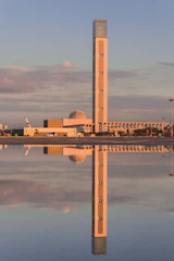 brown and white concrete building near body of water during daytime
