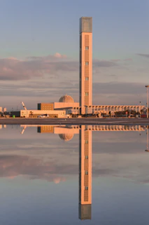 brown and white concrete building near body of water during daytime