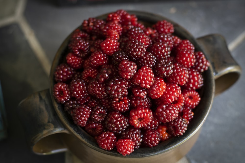 red strawberries on stainless steel bowl