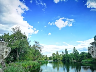 A tranquil river flowing beside an ancient temple, reflecting the sky.