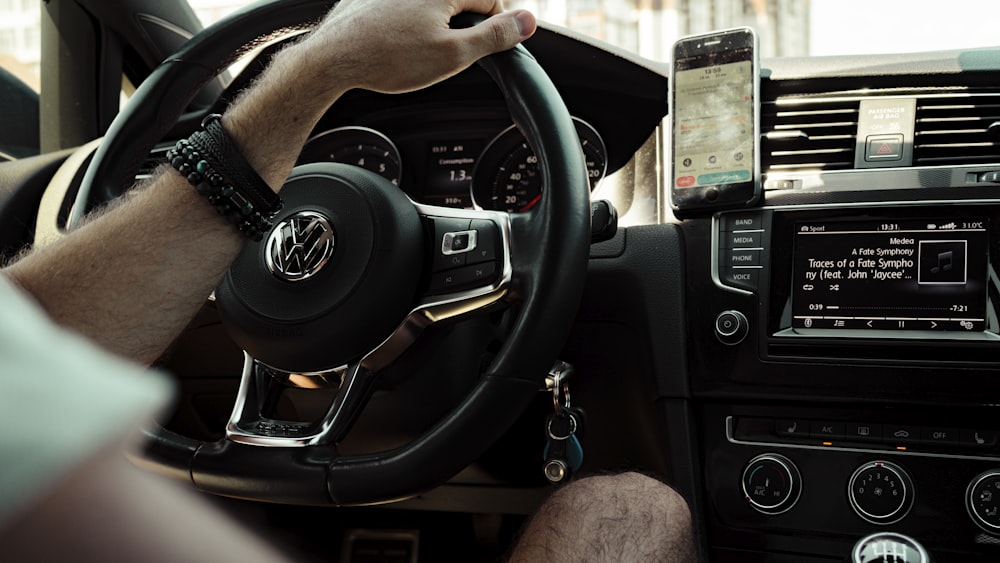 person holding black steering wheel