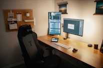 black flat screen computer monitor on brown wooden desk