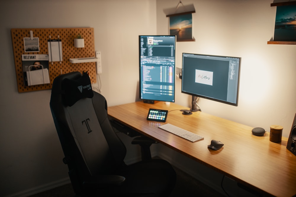 black flat screen computer monitor on brown wooden desk