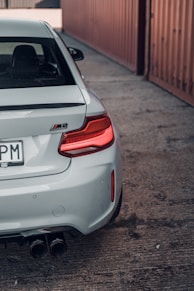 silver bmw m2 parked on road side during daytime